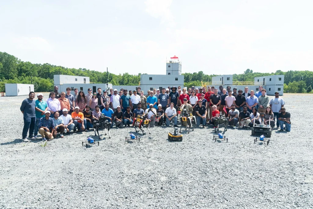 ArtIAMAS 2024 participants posing outdoors with quadruped robots, wheeled robots, and drones